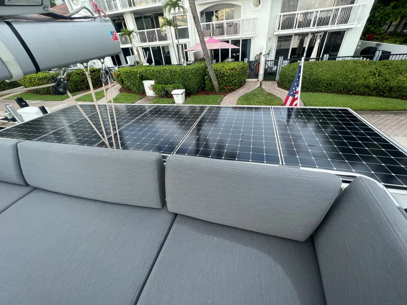 Slide: The Image of 2022 Fountaine Pajot Aura 51 catamaran docked, featuring spacious deck and modern design. - 61