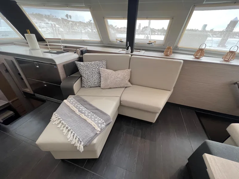 Slide: The Image of Interior of 2022 Fountaine Pajot Aura 51 with TV and fan in wooden cabinet. - 29