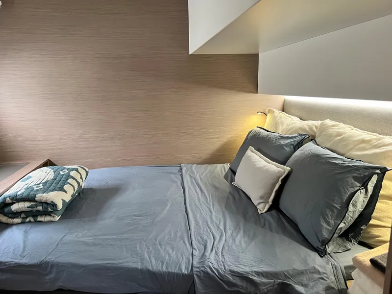 Slide: The Image of Fountaine Pajot Aura 51 yacht with solar panels, docked near a residential area, 2022 model. - 48