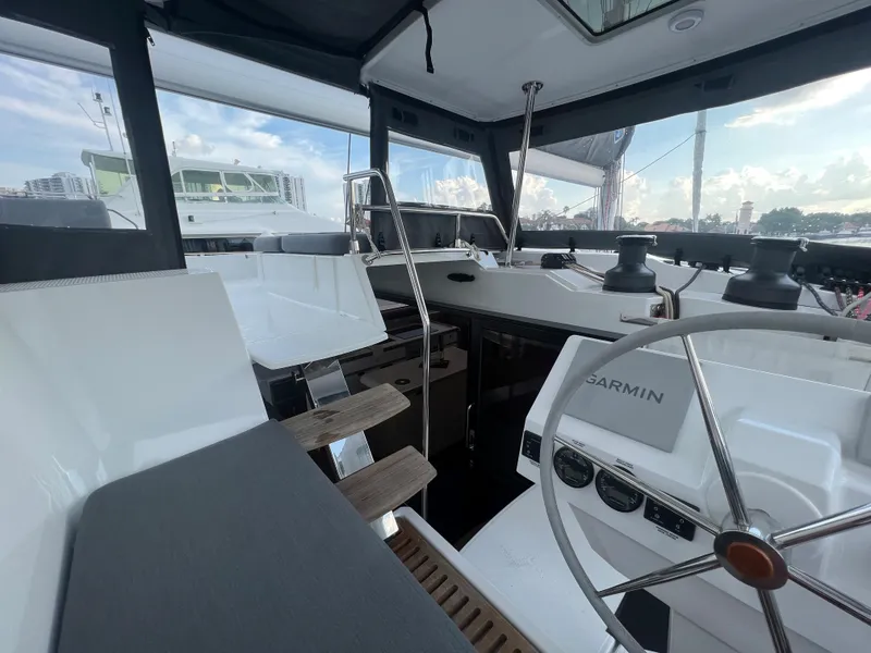Slide: The Image of Sailing catamaran Fountaine Pajot Aura 51, 2022 model, with blue sail on open water. - 57