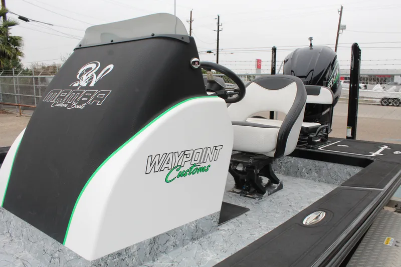 Slide: The Image of 2023 Mamba 227VX boat on trailer, parked outdoors under a blue sky. - 11