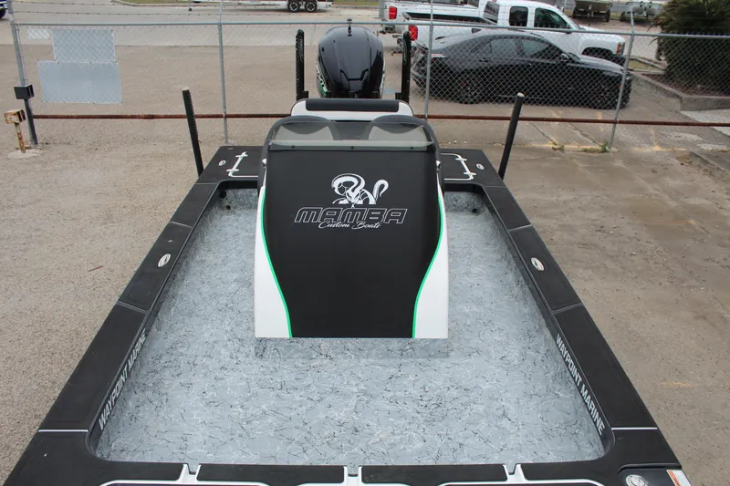 Slide: The Image of 2023 Mamba 227VX boat storage compartments open at a dealership lot. - 13