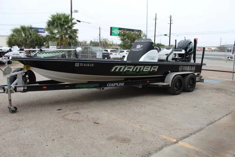 Slide: The Image of 2023 Mamba 227VX boat at dealership, showcasing deck and seating area. - 6