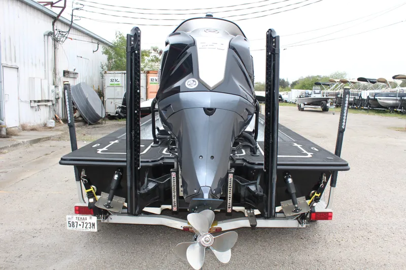 Slide: The Image of 2023 Mamba 227VX boat with sleek black and white design, parked outdoors. - 9