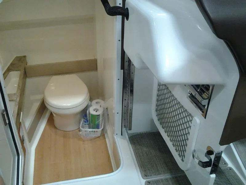 Slide: The Image of 2016 Formula 290 Bowrider boat bathroom interior with toilet and storage. - 13