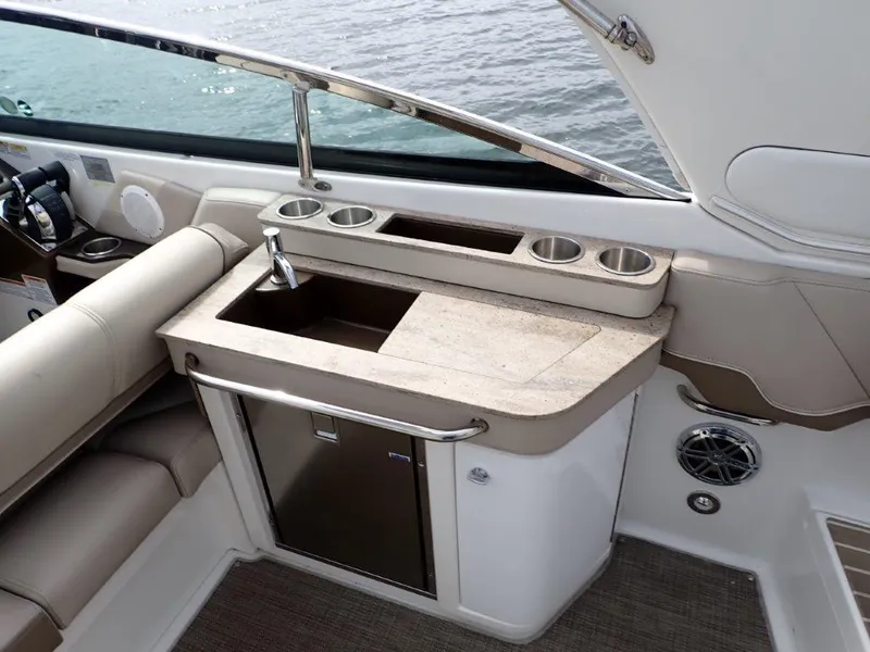 Slide: The Image of 2016 Formula 290 Bowrider interior with sink, cup holders, and mini fridge. - 19