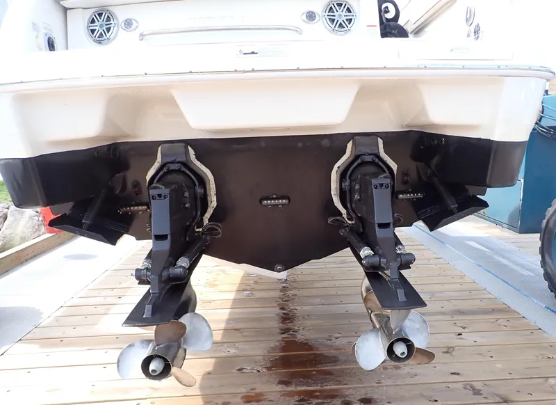 Slide: The Image of 2016 Formula 290 Bowrider boat stern with dual propellers on wooden dock. - 23