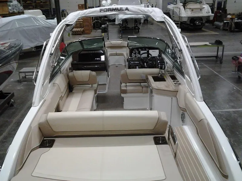 Slide: The Image of 2016 Formula 290 Bowrider boat interior with beige seating and sleek design. - 4
