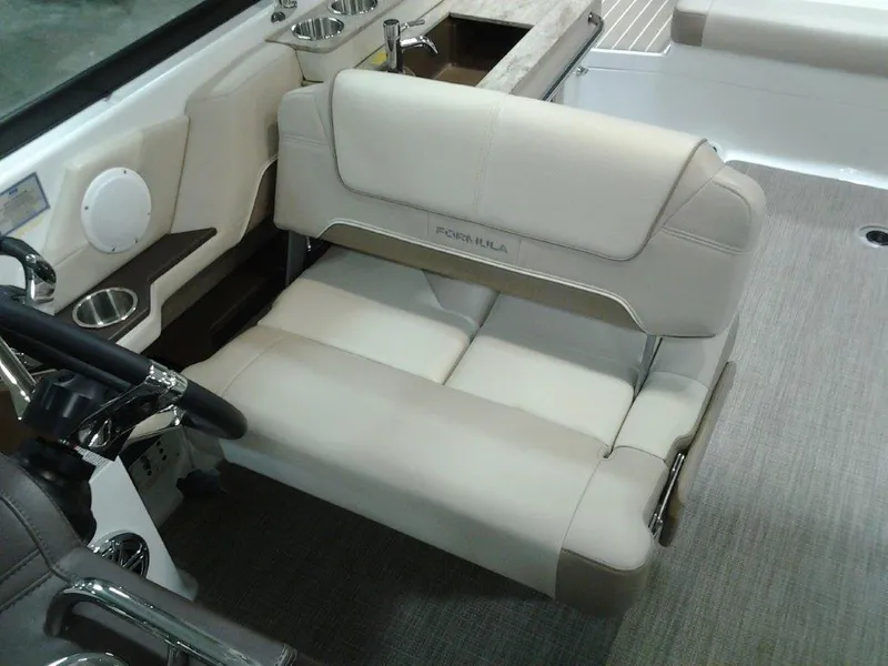 Slide: The Image of 2016 Formula 290 Bowrider interior with beige seating and steering area. - 9