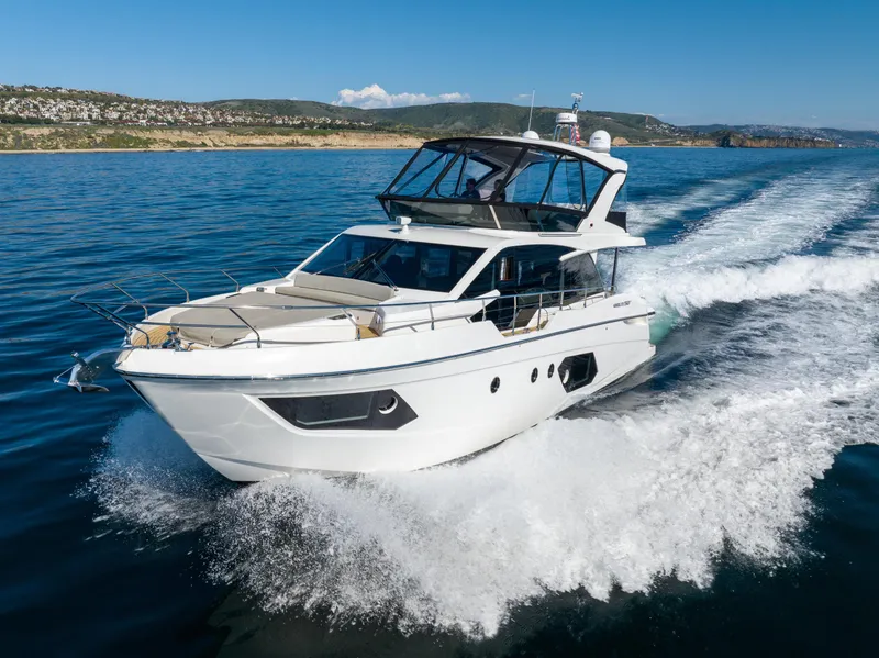 Slide: The Image of 2021 Absolute 50 Fly yacht cruising on open water. - 1