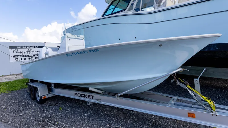 The Image of 1973 SeaCraft 20 boat on trailer, displayed outdoors near marina clubhouse. - 0