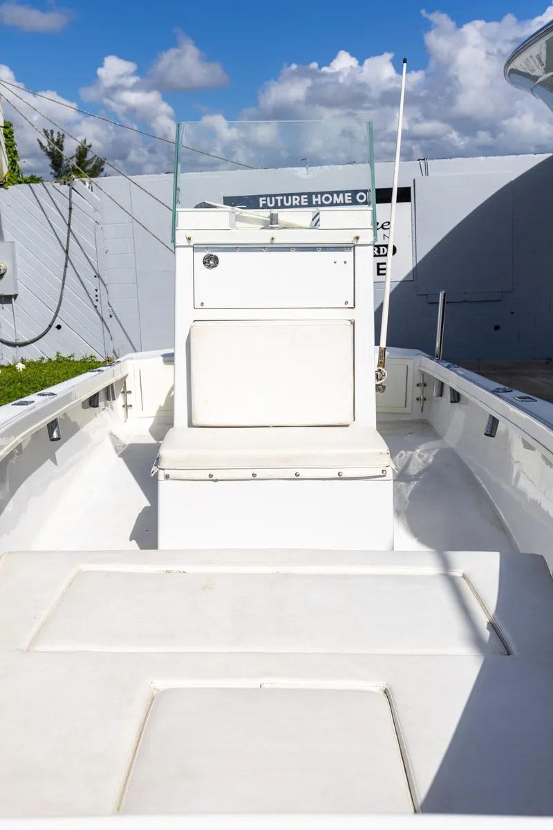Slide: The Image of 1973 SeaCraft 20 boat with white deck and console, under a partly cloudy sky. - 1