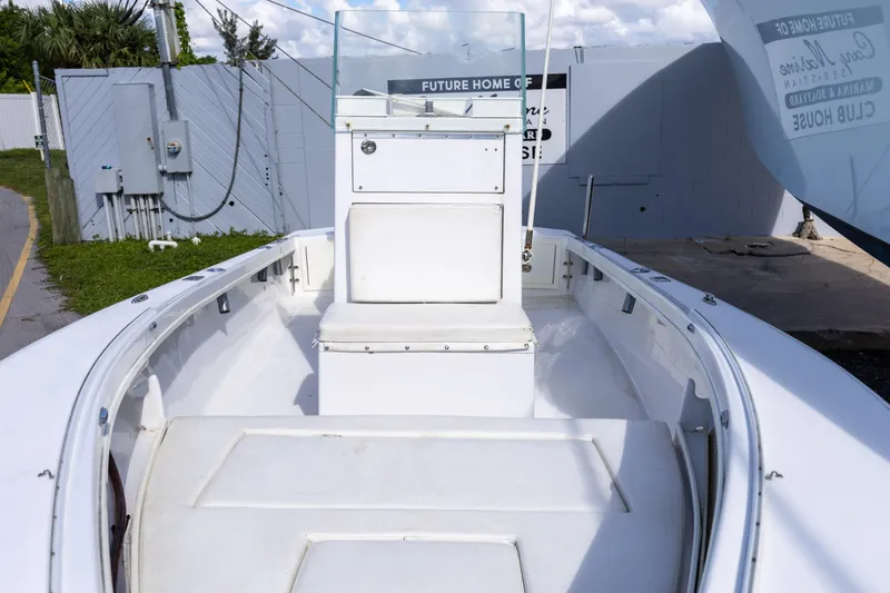 Slide: The Image of 1973 SeaCraft 20 boat with white interior and center console, docked outdoors. - 2