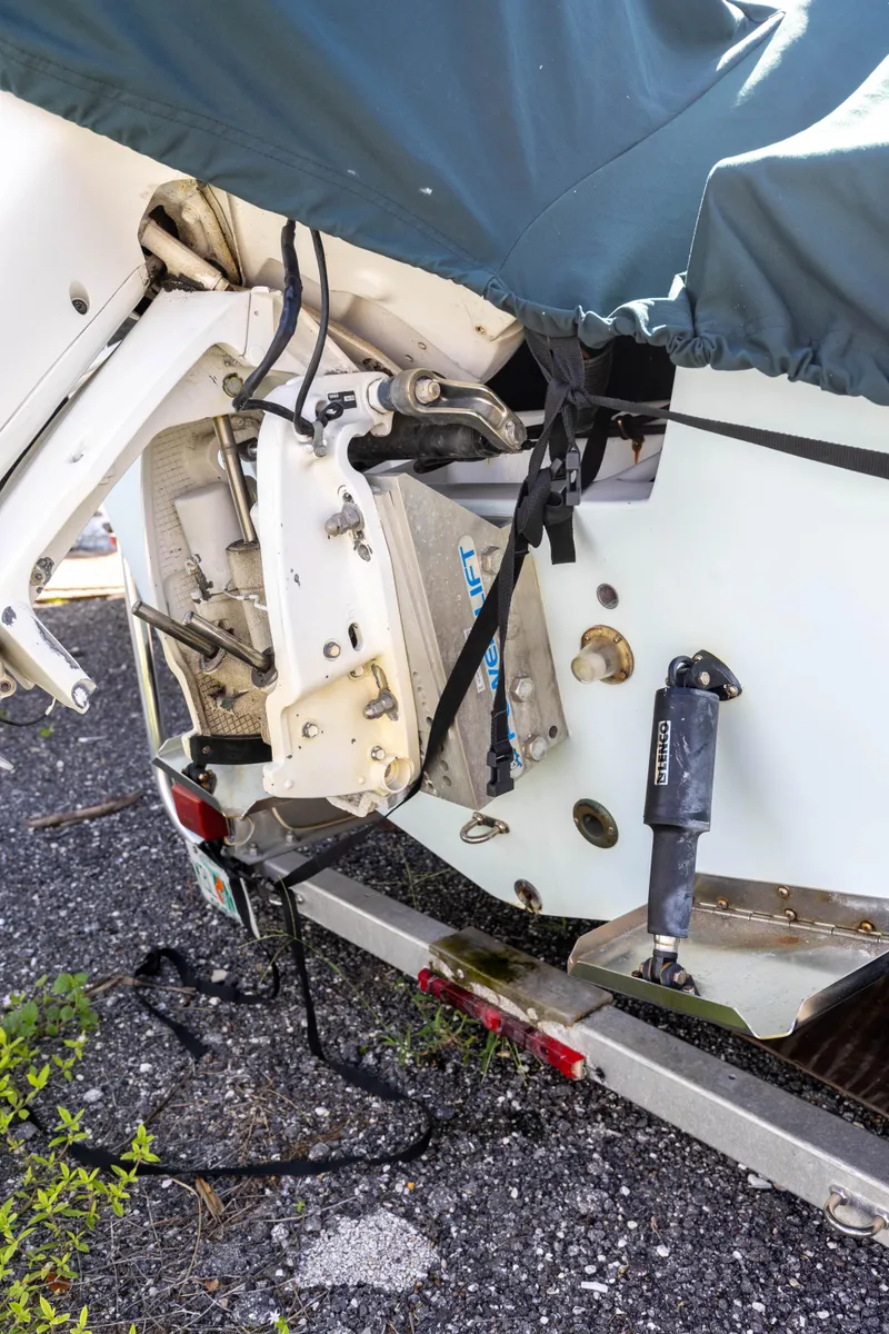 Slide: The Image of 1973 SeaCraft 20 boat on trailer, covered, showing engine mount and hydraulic components. - 6