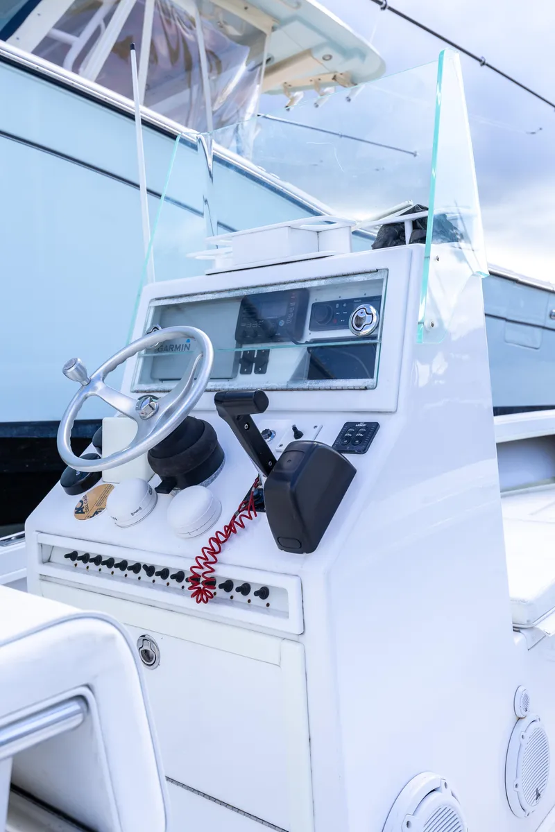 Slide: The Image of 1973 SeaCraft 20 boat console with steering wheel and navigation equipment. - 7