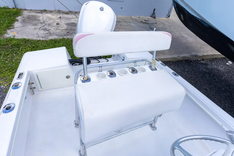 Slide: The Image of 1973 SeaCraft 20 boat interior with white seating and cup holders. - 8