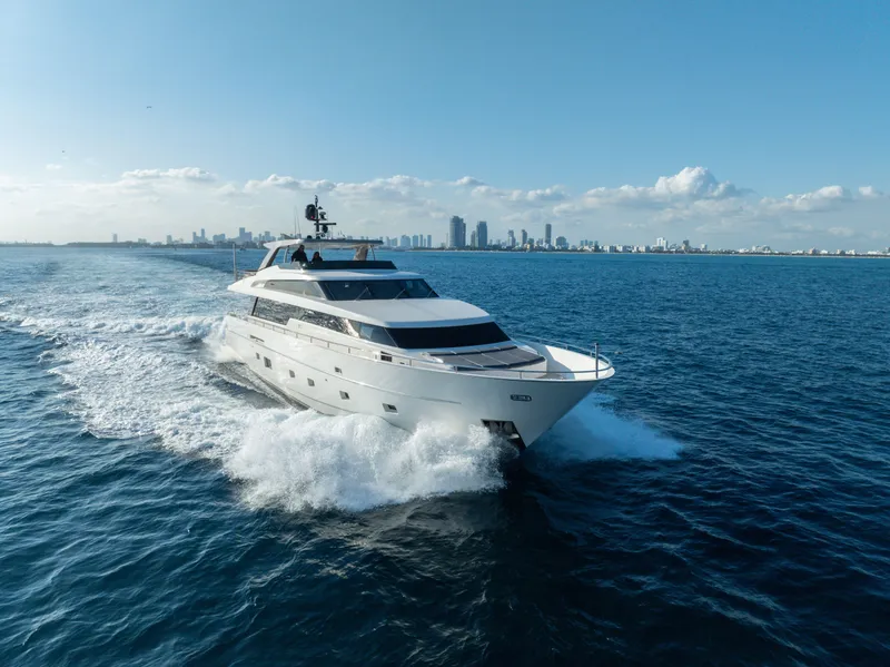 Slide: The Image of Sanlorenzo SL94 yacht cruising on open sea, 2012 model, city skyline in background. - 1