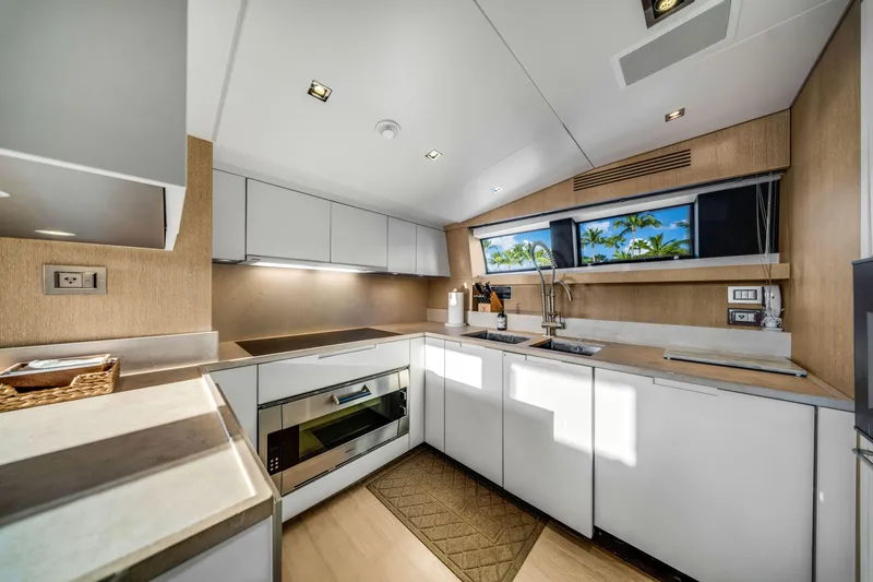 Slide: The Image of Modern kitchen interior on 2012 Sanlorenzo SL94 yacht, featuring sleek cabinetry and appliances. - 34