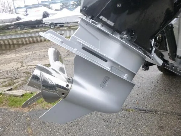 Slide: The Image of 2025 Ranger 622FS Pro boat motor with shiny propeller on wet pavement. - 11