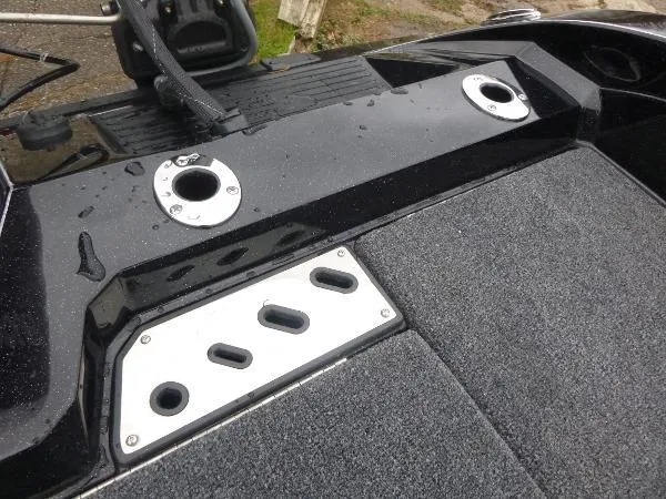 Slide: The Image of 2025 Ranger 622FS Pro boat deck with rod holders and carpeted surface. - 15