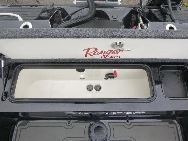 Slide: The Image of 2025 Ranger 622FS Pro boat storage compartment with open lid, showcasing interior features. - 19