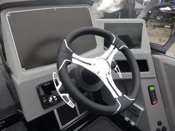 Slide: The Image of 2025 Ranger 622FS Pro boat dashboard with modern steering wheel and digital display. - 24