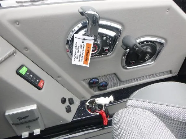 Slide: The Image of 2025 Ranger 622FS Pro boat dashboard with controls and warning tag. - 26