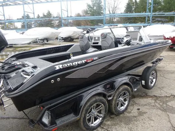Slide: The Image of 2025 Ranger 622FS Pro boat with dual axles, sleek black design, parked outdoors. - 3