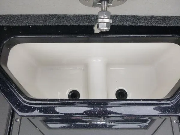 Slide: The Image of Livewell compartment in 2025 Ranger 622FS Pro boat, featuring dual drains and sleek design. - 30