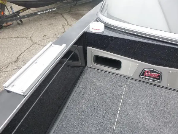 Slide: The Image of 2025 Ranger 622FS Pro boat interior with carpeted deck and storage compartments. - 33