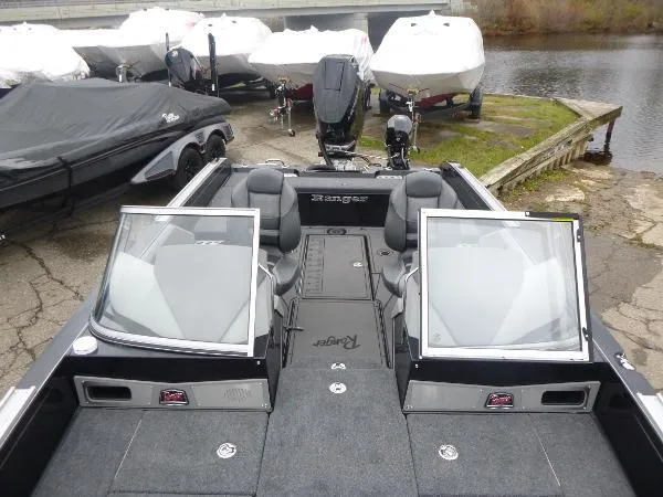 Slide: The Image of 2025 Ranger 622FS Pro boat with dual windshields, docked near water. - 39