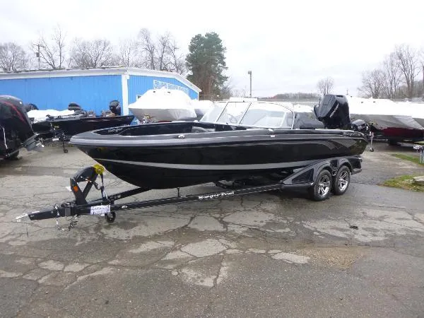 Slide: The Image of 2025 Ranger 622FS Pro boat on trailer, parked outdoors near blue building. - 7