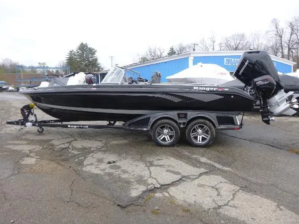 Slide: The Image of 2025 Ranger 622FS Pro boat on trailer, black exterior, parked outdoors. - 8
