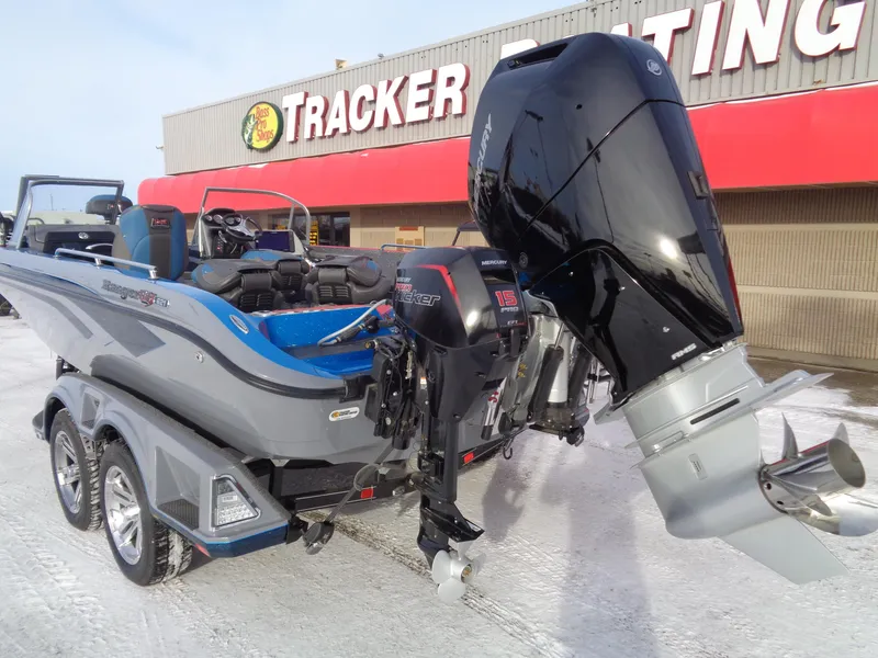 Slide: The Image of 2025 Ranger 621FS Cup Equipped boat with powerful outboard motor, parked outside Tracker store. - 6