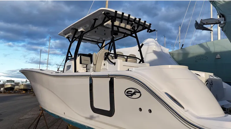 Slide: The Image of 2022 Sea Fox 328 boat with sleek design, docked under a cloudy sky. - 10