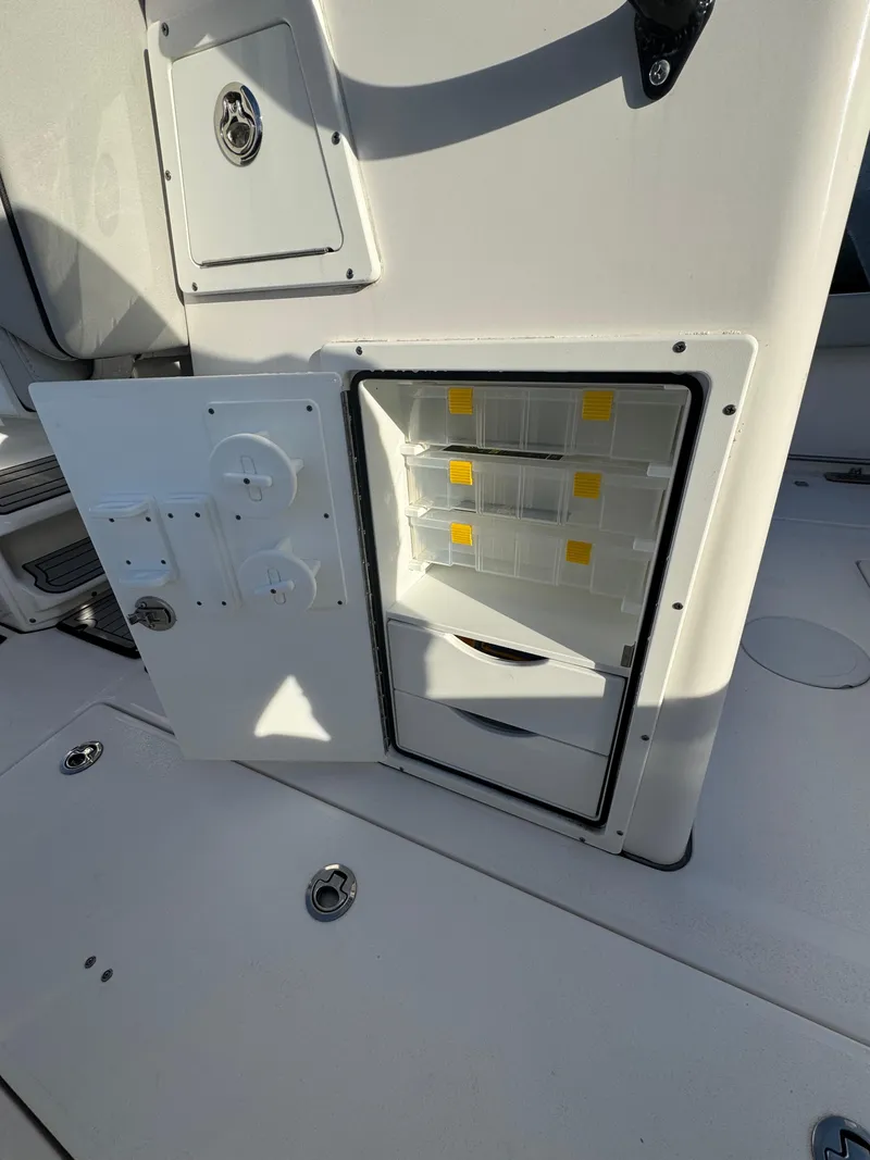 Slide: The Image of 2022 Sea Fox 328 boat storage compartment with open hatch and organized interior. - 15