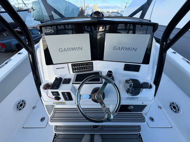 Slide: The Image of 2022 Sea Fox 328 boat dashboard with dual Garmin displays and steering wheel. - 17