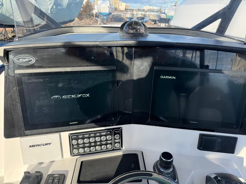 Slide: The Image of 2022 Sea Fox 328 boat dashboard with Garmin displays and Mercury controls. - 21