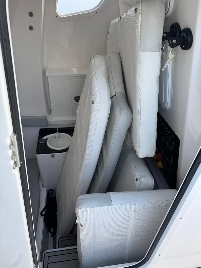 Slide: The Image of 2022 Sea Fox 328 interior with stacked cushions and compact storage. - 25