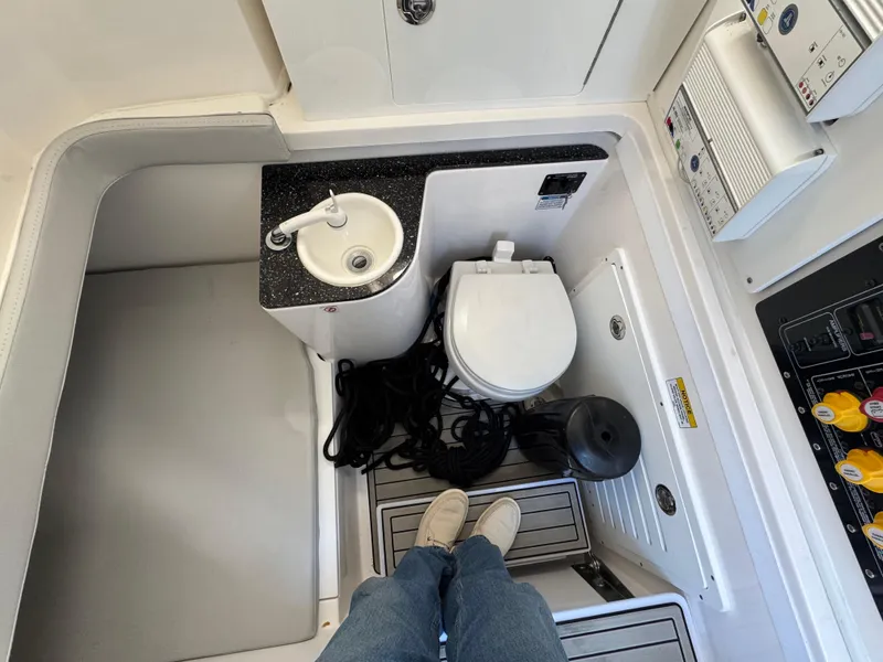 Slide: The Image of 2022 Sea Fox 328 boat interior with sink, toilet, and control panel. - 26