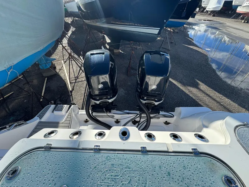 Slide: The Image of 2022 Sea Fox 328 boat with dual outboard engines in a marina. - 36