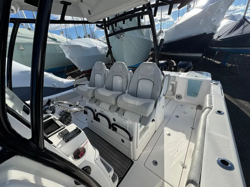 Slide: The Image of 2022 Sea Fox 328 boat interior with three cushioned seats and control panel. - 39
