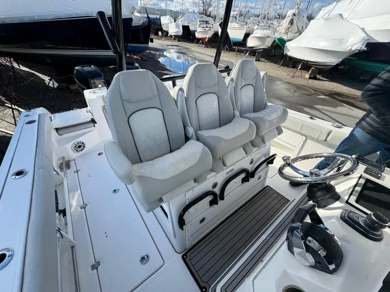 Slide: The Image of 2022 Sea Fox 328 boat interior with three cushioned seats and steering console. - 40