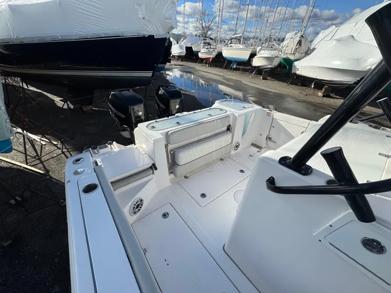 Slide: The Image of 2022 Sea Fox 328 boat interior with dual engines, docked among other boats. - 41