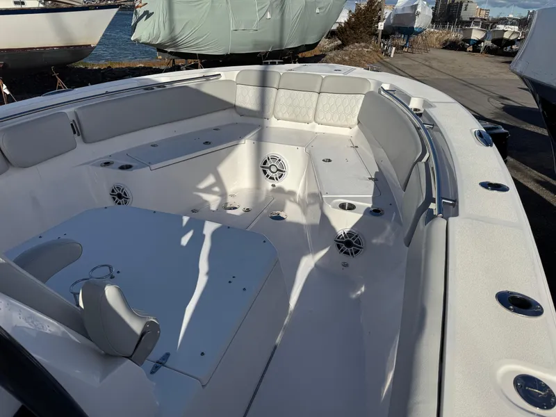 Slide: The Image of 2022 Sea Fox 328 boat interior with seating and speakers, docked near water. - 42