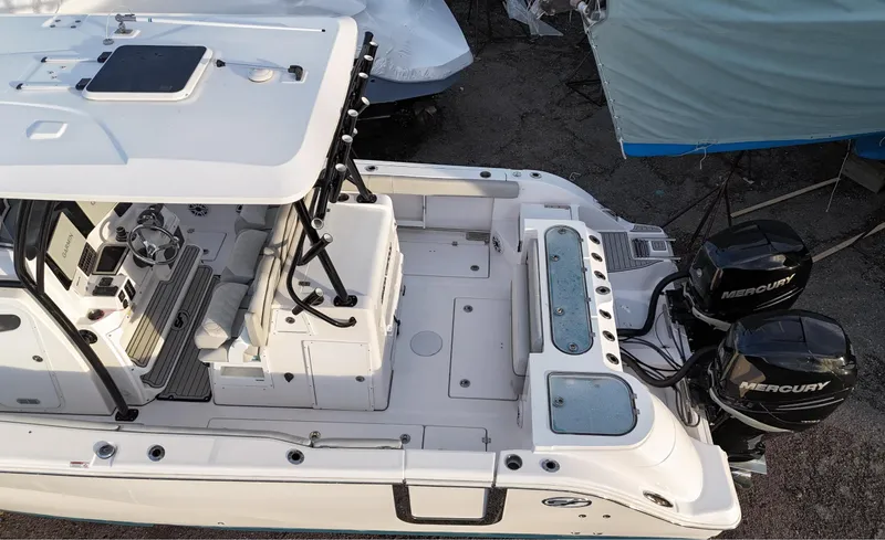 Slide: The Image of 2022 Sea Fox 328 boat with dual Mercury engines, spacious deck, and modern controls. - 7