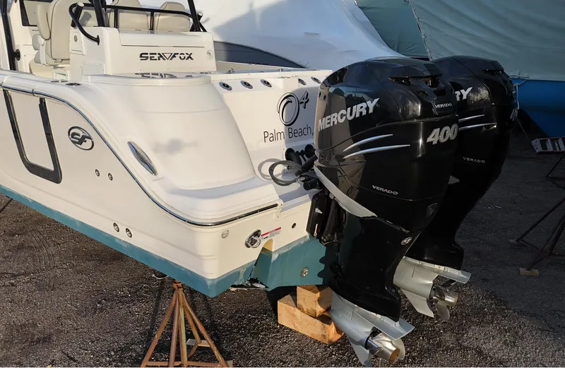 Slide: The Image of 2022 Sea Fox 328 boat with dual Mercury 400 engines, parked on a stand. - 9
