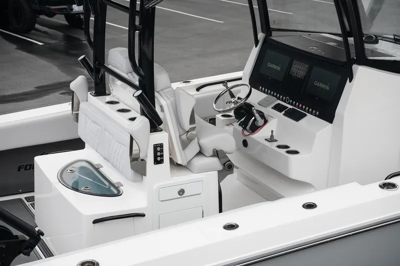 Slide: The Image of 2023 Fountain Bluewater 38 Tournament Edition boat cockpit with modern controls and seating. - 12