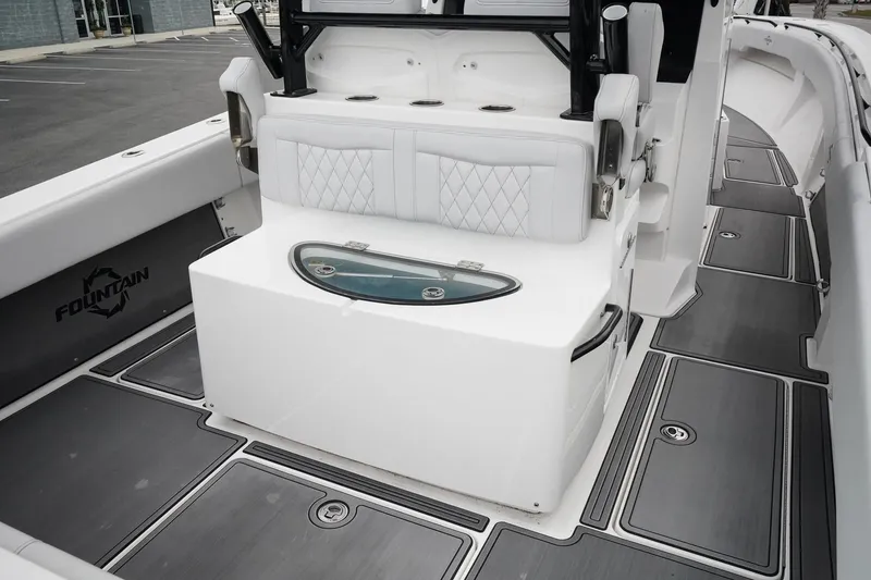Slide: The Image of 2023 Fountain Bluewater 38 Tournament Edition boat interior with seating and storage. - 16