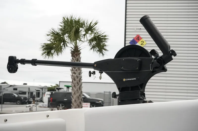 Slide: The Image of Cannon downrigger on 2023 Fountain Bluewater 38 Tournament Edition boat, palm tree in background. - 21